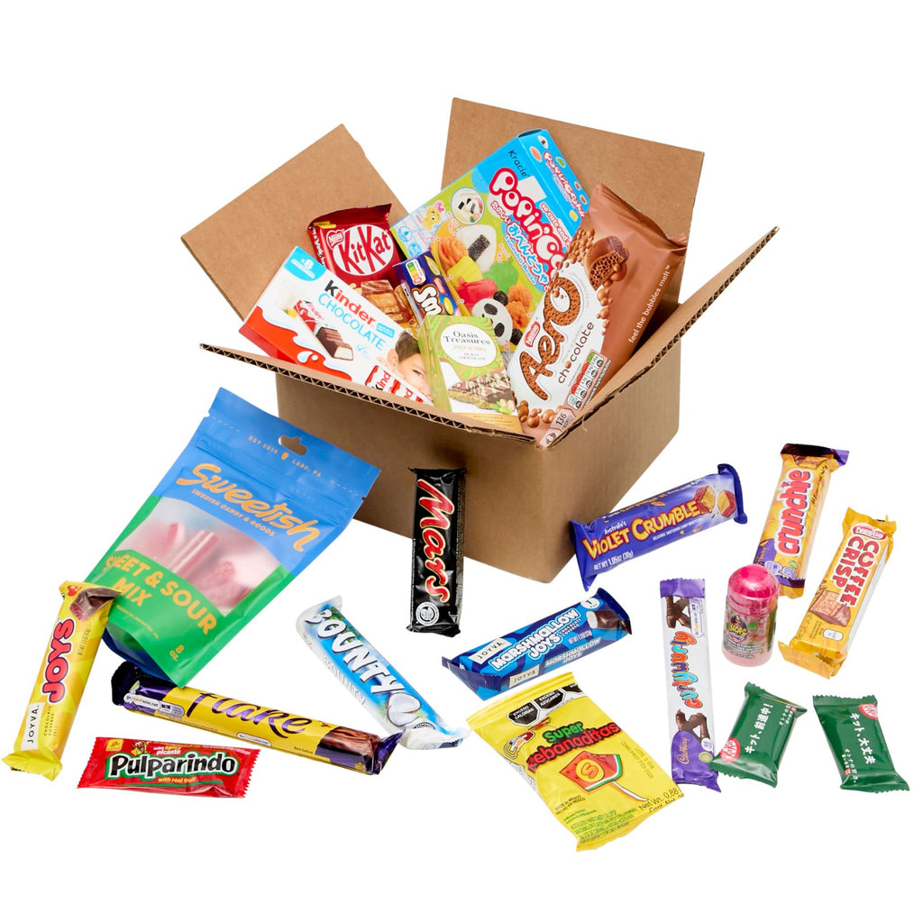 Open cardboard box filled with various candy bars on a white background