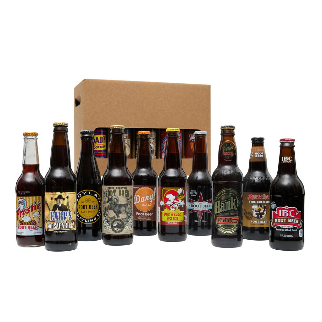 Assorted root beer bottles with labels in front of a cardboard box on a white background
